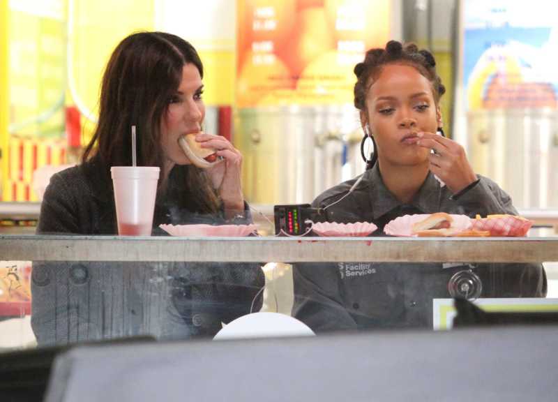 Sandra Bullock and Rihanna eat hot dogs and french fries on the set of OCEANS 8